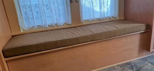 One custom bench custom made in boxed construction with Sunbrella Teak fabric with same trim.