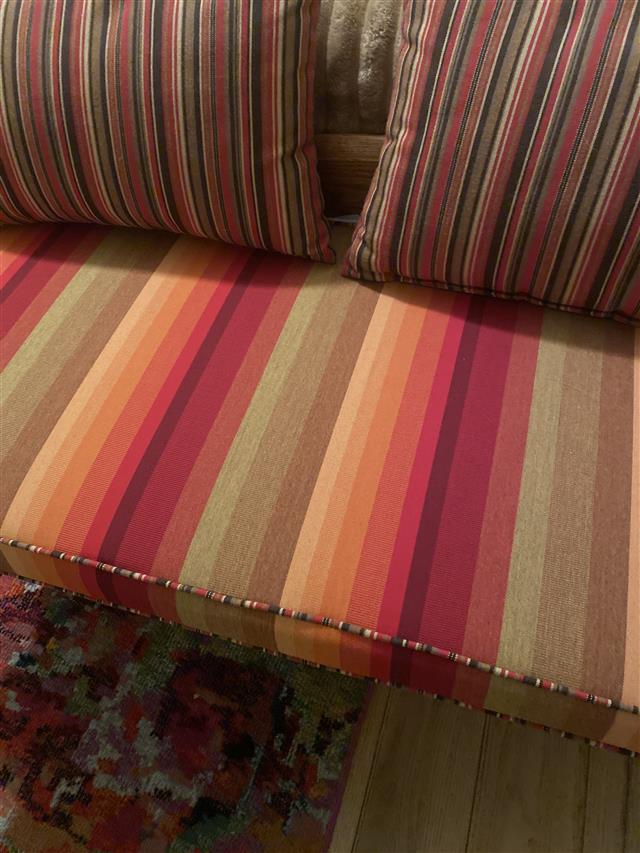 1 custom bench cushion - trapezoid - set in boxed construction 2 inches thick with Sunbrella Astoria Sunset fabric with double welt Sunbrella Dorsett Cherry