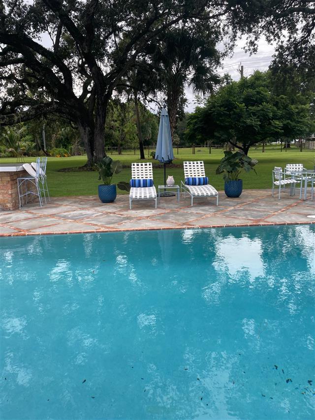 2 custom bolster pillows with Sunbrella Milano Cobalt fabric and single welt Sunbrella Navy trimming, polyester fiber