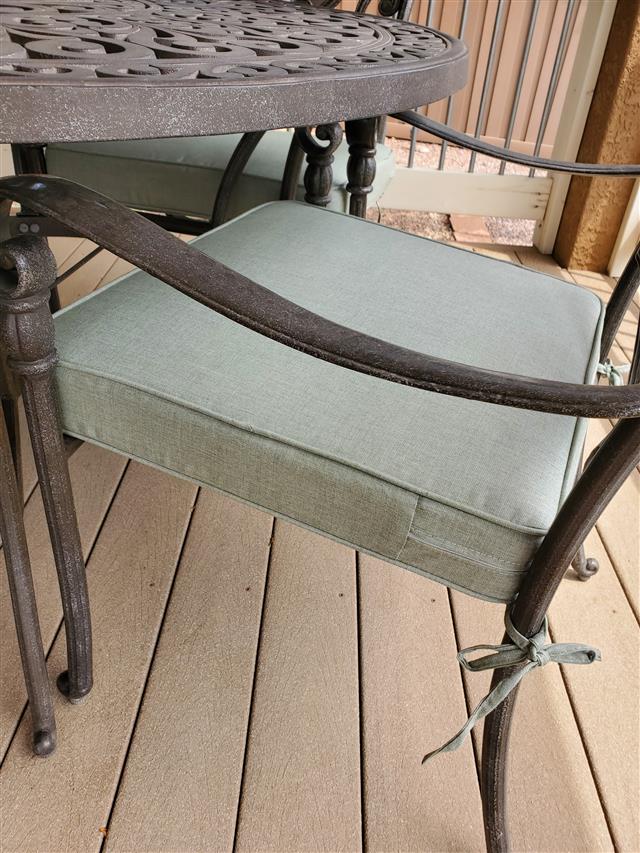 4 custom trapezoid seat cushions set in boxed construction with Sunbrella Cast Oasis fabric, double welt Cast Oasis trimming, reticulated foam with fiber batting, 2 ties at back corners